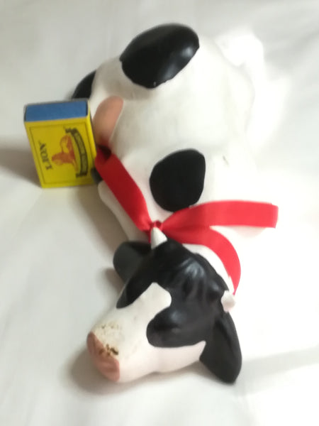 Black & White Ceramic Cow with Red Ribbon Around The Neck
